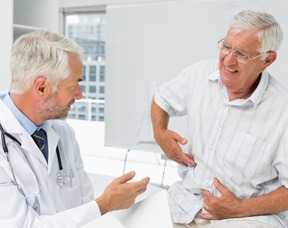 Doctor Explaining Signs and Symptoms of Prostate Cancer to Patient