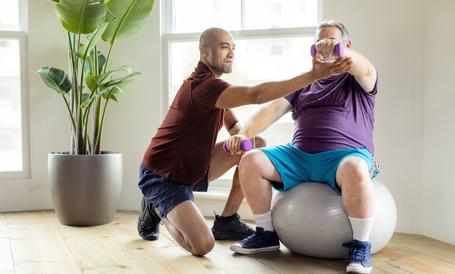 Man Exercising on Ball for Urologic Workout